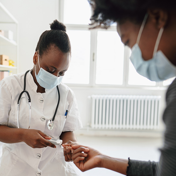 female doctor checking the patient's glucose level