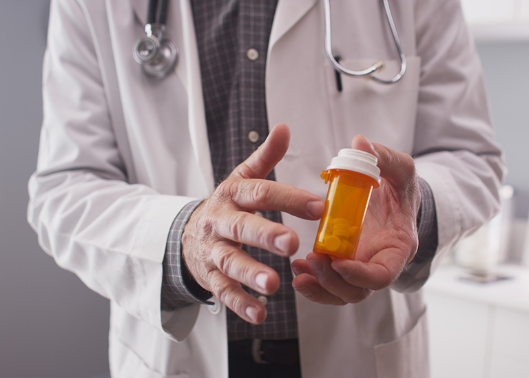 doctor showing pills in a bottle