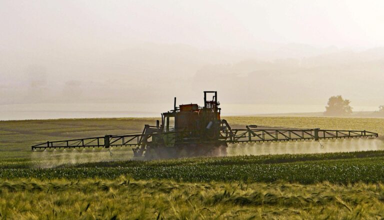 Farm equipment spraying crops in Oshawa, Ontario, Canada