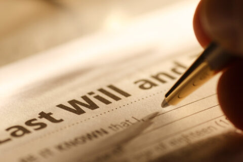 Person filling out last will paperwork