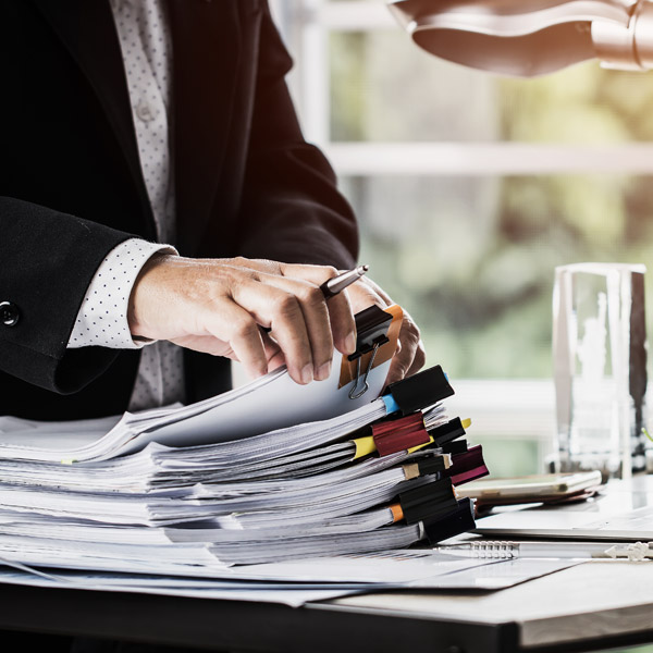 close up of lawyer going through a pile of documents
