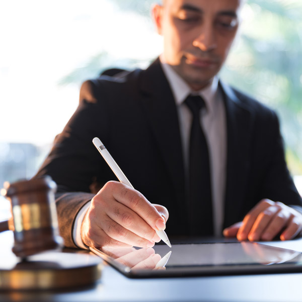 lawyer signing documents on smart device