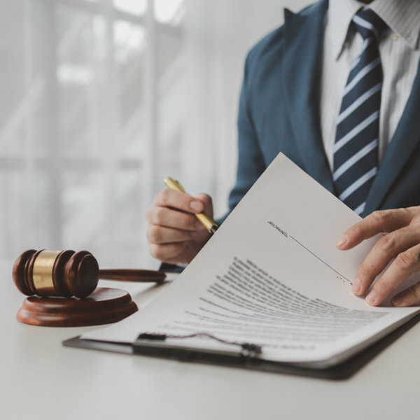 close up of lawyer signing papers